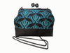 Large kisslock bag made from an art nouveau style design featuring black brolga silhouettes on a blue patterned background. The bag has a cork base and a long gunmetal chain.