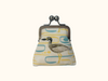 kisslock coin purse with a beach stone curlew on an abstract patterned background