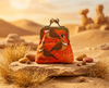 Coin purse with spinifex pigeons on an orange mottled background