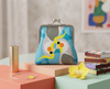 large coin purse with two stylised cockatiels, one upside down, against a blue spotted background