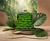 large kisslock coin purse with a pattern of bright green ants on a lime and khaki striped background