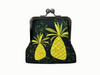 large kisslock purse with two bright mid-century modern inspired pineapples on a black background