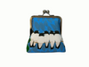 large kisslock coin purse with a row of white-breasted woodswallows bunched together on a branch against a blue background of falling leaves