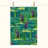 linen tea towel covered with stylised print of black bitterns and black catfish against a watery background with reed and rocks