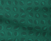 Green fabric with a pattern of seedpod shapes