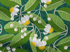 fabric printed with yellow and white tamanu flowers and green leaves on teal green background