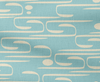 Patterned fabric with abstract off-white design on a blue background