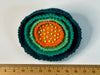 layered felt flower brooch in orange, sea green and deep teal with a beaded centre