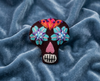 Deep burgundy sugar skull felt brooch with blue and purple eyes
