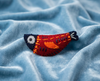 Felt fish brooch in red and blue