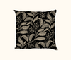 cushion with beige pattern of Atlas moth and Atlas Croton on a black background