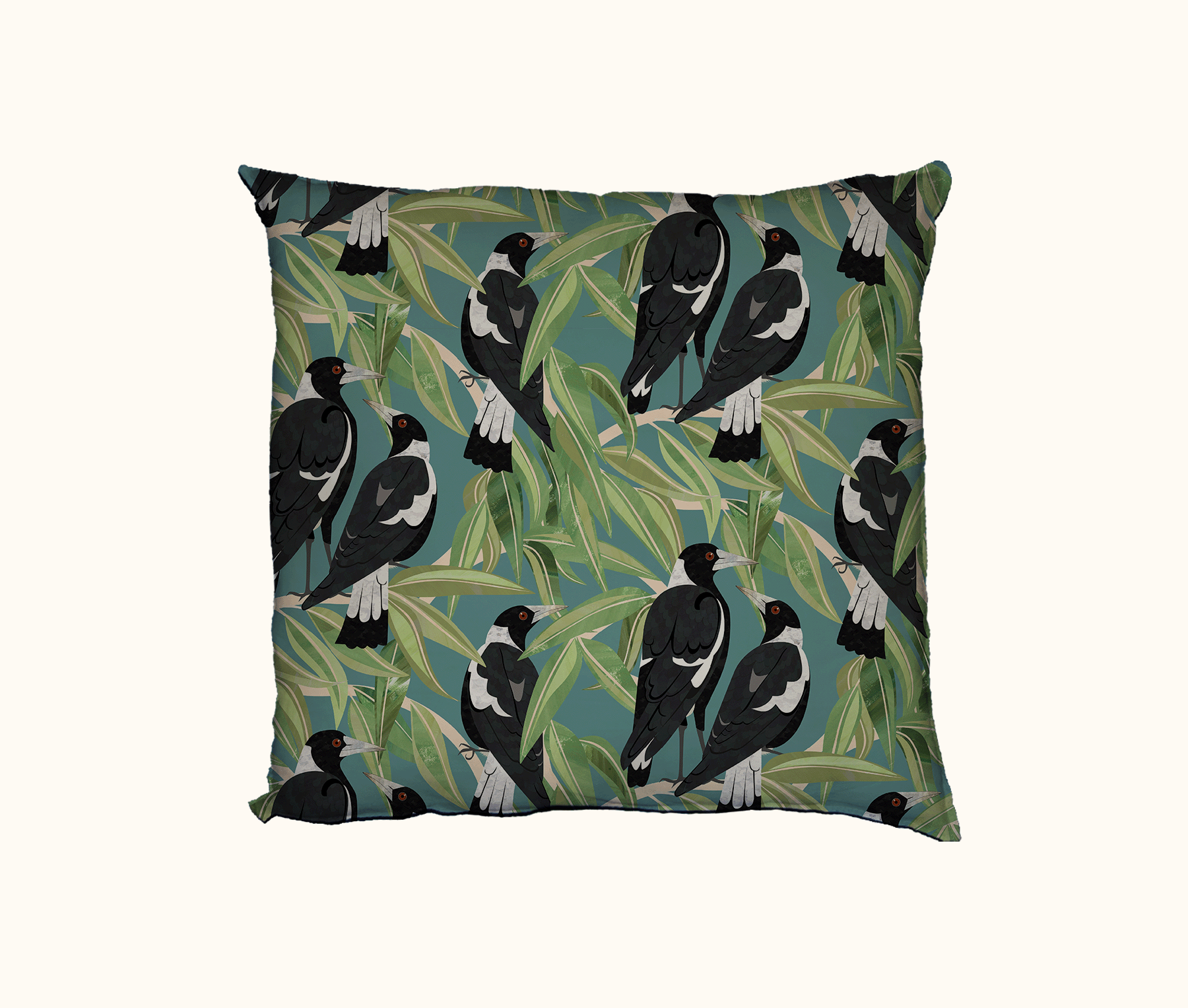 cushion with an all-over pattern of Australian magpies in a gum tree against a light blue-green background