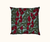 cushion with rosella flowers and leaves on a pale blue-green background