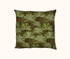 cushion with a pattern of cycads against a leaf textured background