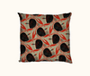cushion printed with a flame-backed fiddler crab pattern in black and red-orange against a wavy beige background, with a mid-century modern feel