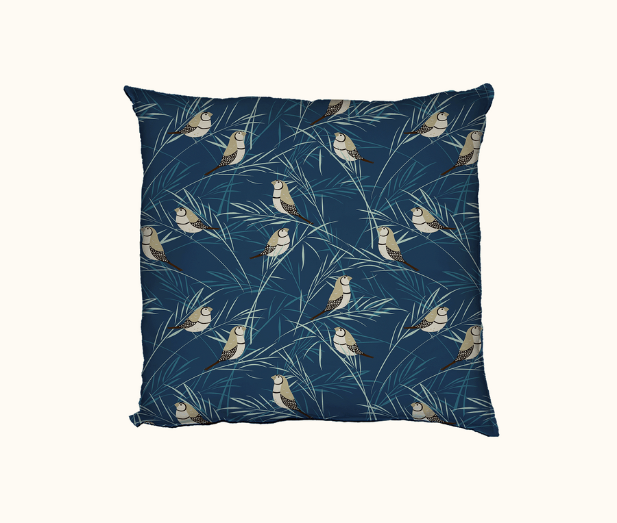 cushion with a pattern of double-barred finches on grasses on a blue background