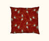 cushion with a pattern of double-barred finches on grasses on a red background