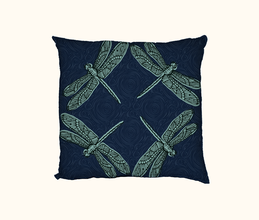 cushion with four large pale blue dragonflies against a dark blue swirly background