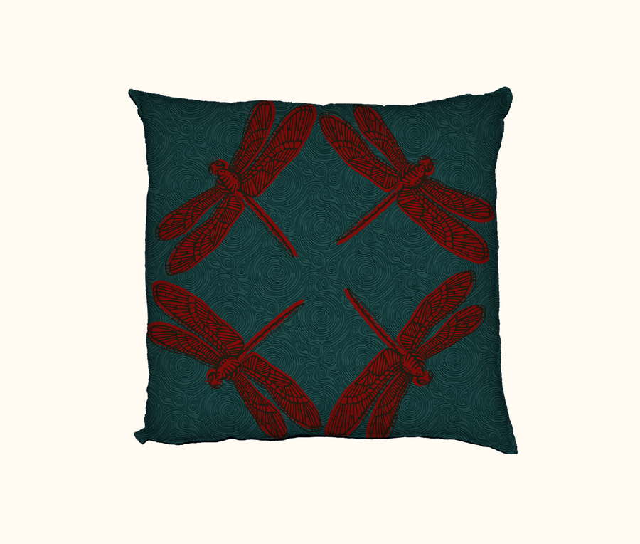 cushion with four large red dragonflies against a teal-green swirly background