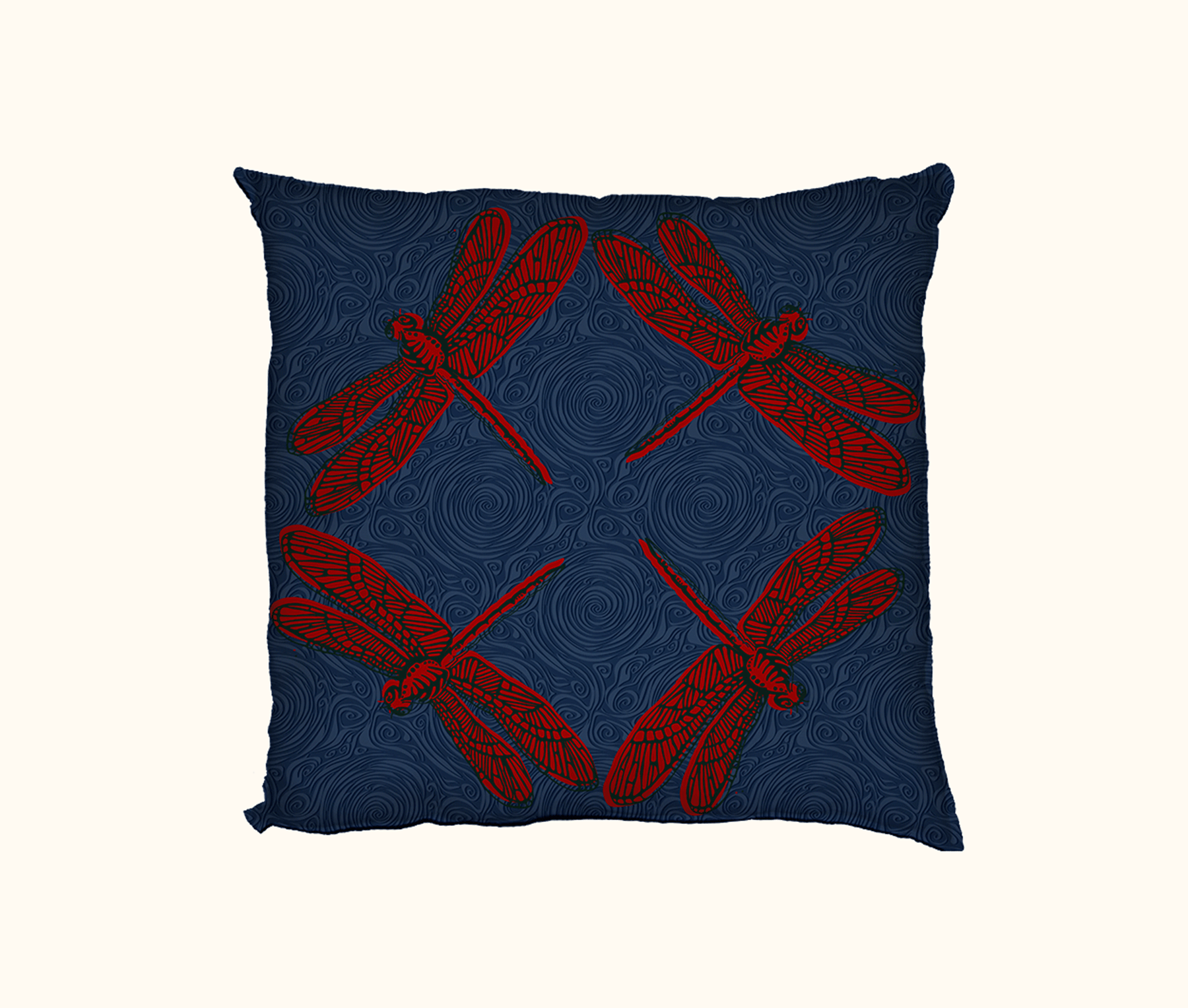 cushion with four large red dragonflies facing  out towards the corners on a dark blue swirly background
