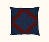 cushion with four large red dragonflies facing  out towards the corners on a dark blue swirly background