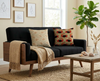 cushion with flame-backed fiddler crab and seaweed pattern on beige background and cushion with dog-whelk pattern on a black couch