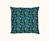 cushion with a pattern of stylised  forest kingfishers against a pattern of teal leaves