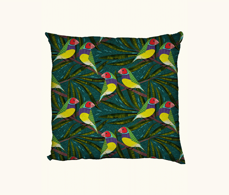 cushion featuring stylised Gouldian finches with red faces against a green and teal leafy background