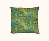 cushion with pattern of green tree frogs, pebbles and grasses in green