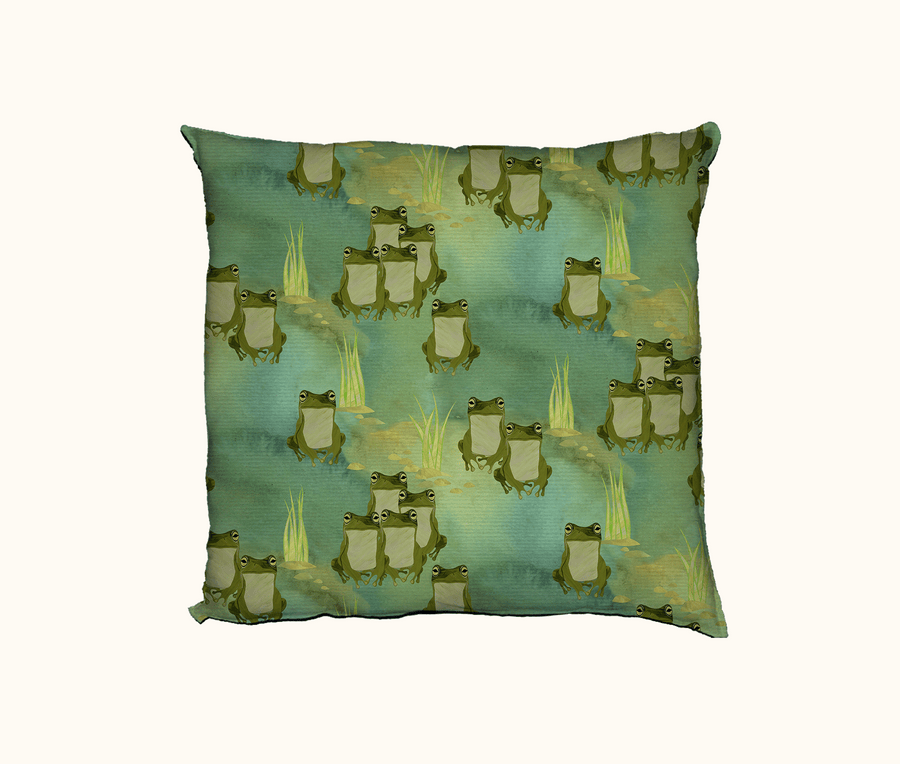 cushion with pattern of green tree frogs, pebbles and grasses in green