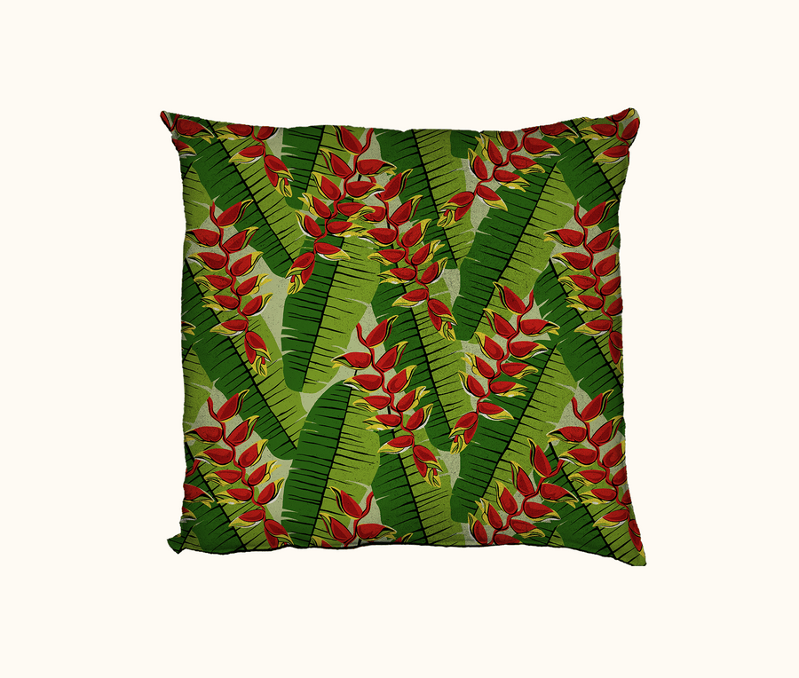 cushion with red and yellow heliconia flowers against a backdrop of heliconia leaves with a newsprint dot overlay