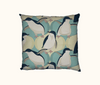 cushion printed with a repeat pattern of little penguins against a pale blue-green and sand coloured ogee design