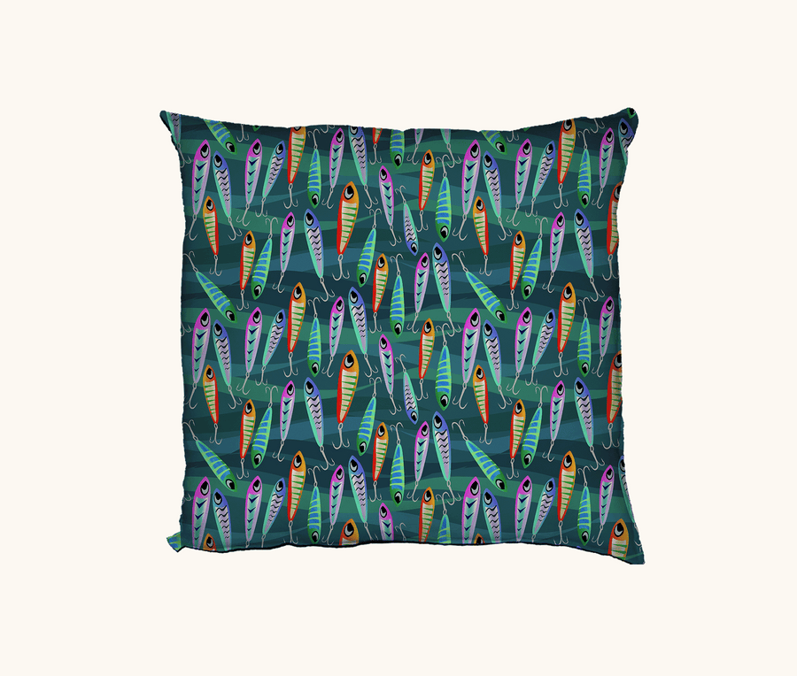 cushion with colorful fishing lure pattern on a blue-green background