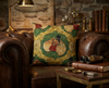 cushion featuring a frill-necked lizard in a top hat and ruffle in an ogee pattern made of cogs against a green mechanical background on an old leather armchair