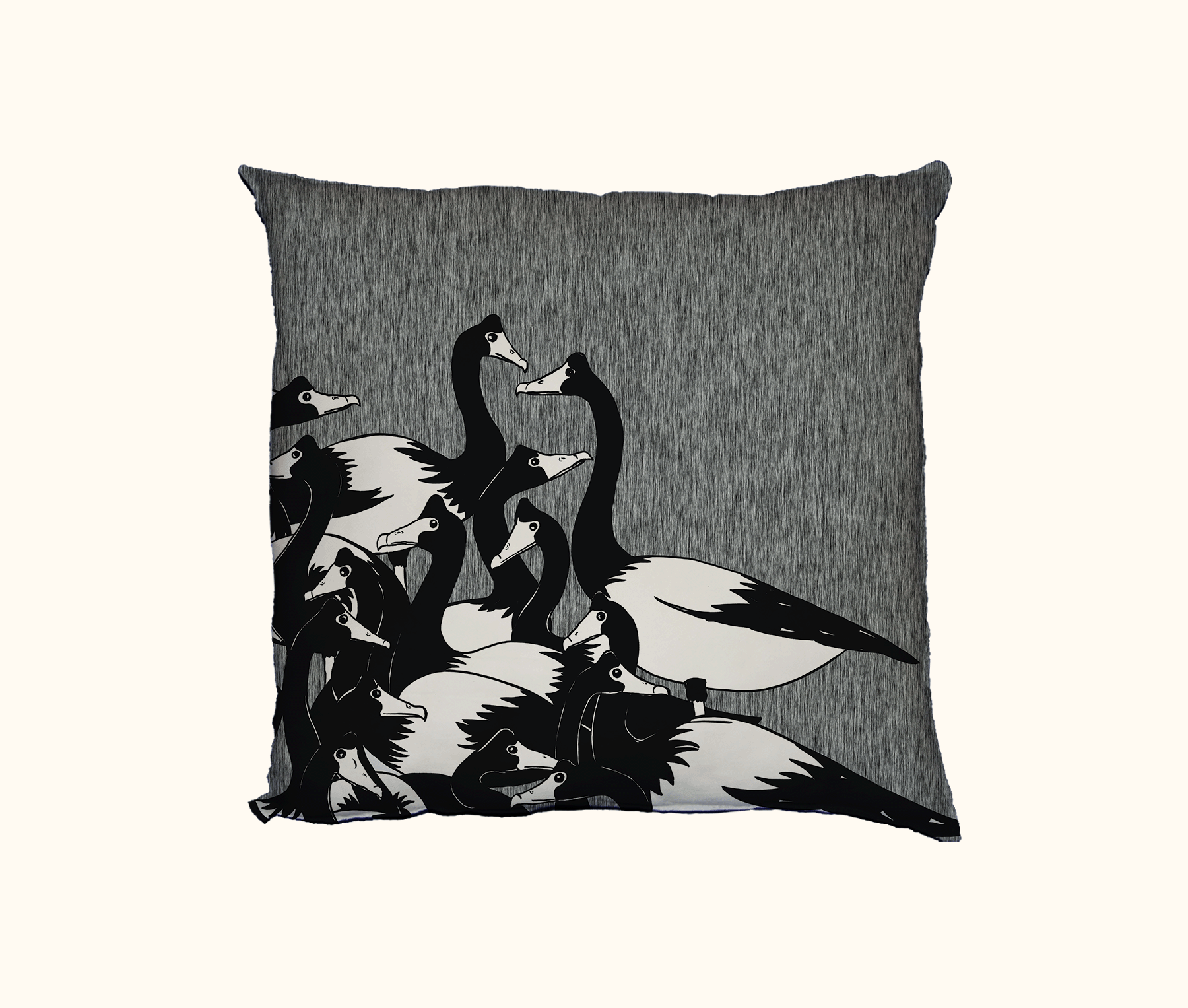 cushion with cluster of black and white magpie geese against a mottled background