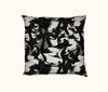 cushion with all-over black and white pattern of magpie geese against a mottled background