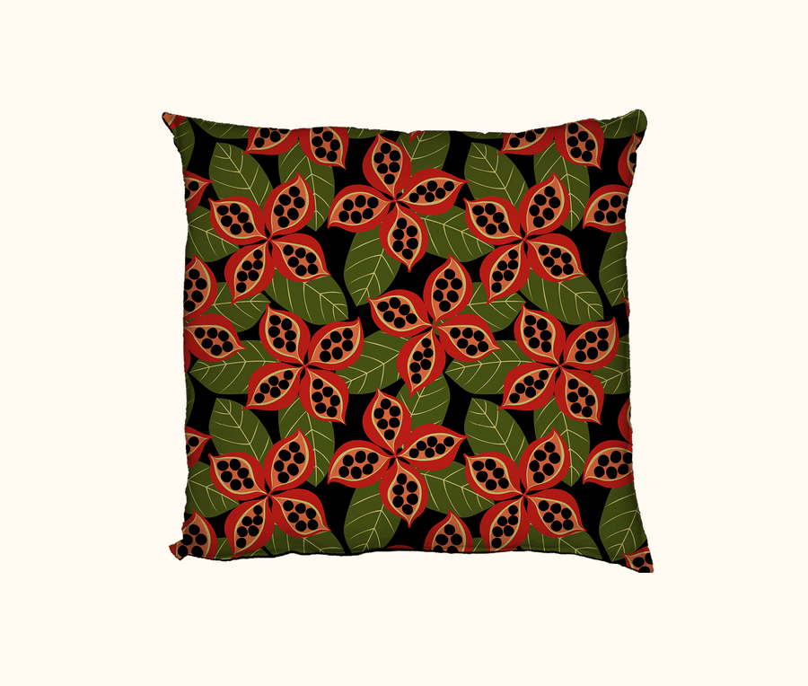 cushion with native peanut seedpods against a pattern of green leaves on a black background