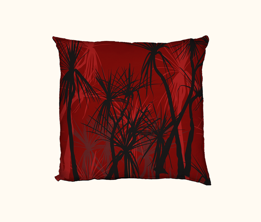 cushion with pattern of black pandanus on a red layered background