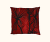 cushion with pattern of black pandanus on a red layered background