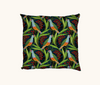 cushion with a pattern of rose-crowned fruit doves, leaves and berries on a dark blue background