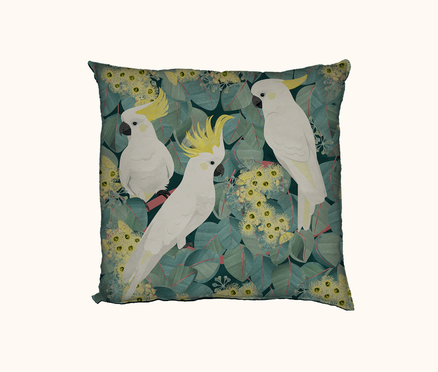 cushion featuring three sulphur crested cockatoos in a flowering red box tree