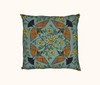 cushion featuring a coloured lino-cut design of four rainbow bee-eaters facing towards the centre of the cushion surrounded by kapok flowers and buds on a blue background