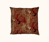 cushion patterned with stylised red-backed fairywrens on speargrass against a red background 