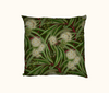 cushion cover with river red gum pattern with leaves and cream blossoms on a dark green background