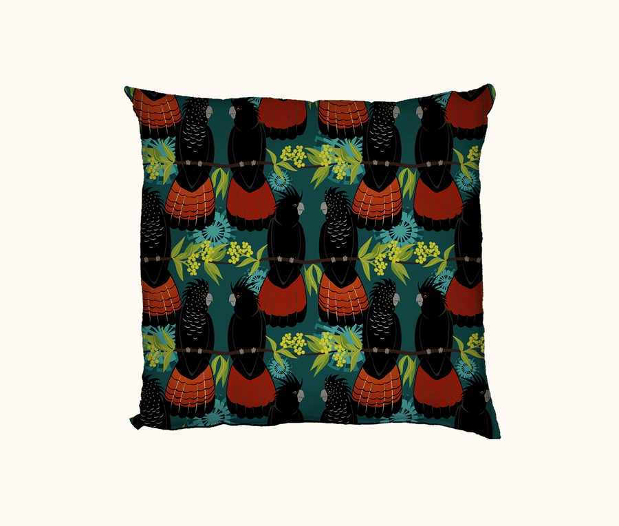 cushion featuring a pattern of red-tailed black cockatoos on wattle branches