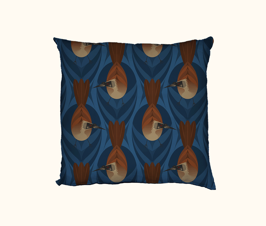 cushion featuring highly stylised silver-crowned friarbirds on a blue leaf-like pattern