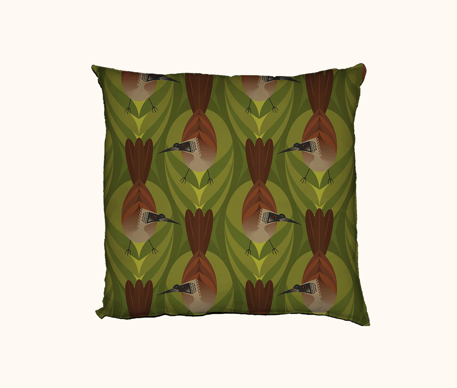 cushion featuring highly stylised silver-crowned friarbirds on a green leaf-like pattern