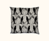 cushion featuring an all-over pattern of spangled drongos facing each other on a grey and white background