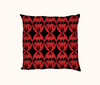 cushion patterned with Sturt's desert pea flowers against black diamonds set in red ovals on a red background