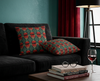 cushions featuring Sturt's desert pea on a geometric background of teal and green on a black couch